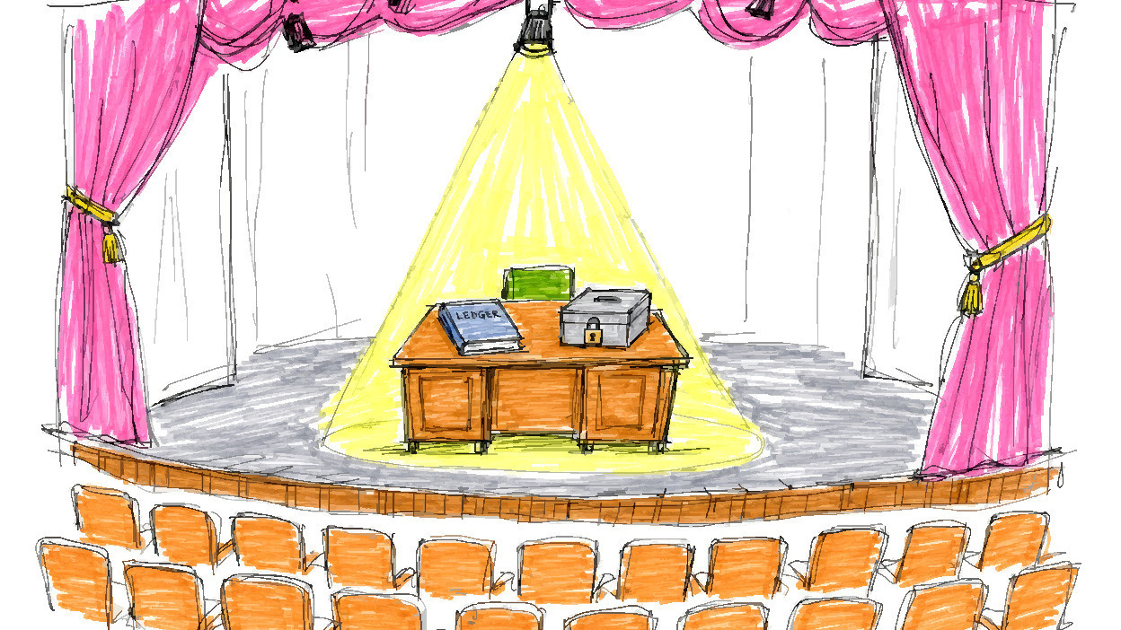 An empty theater stage with pink curtains and rows of orange seats facing a desk holding a ledger and a locked cash box under a spotlight.